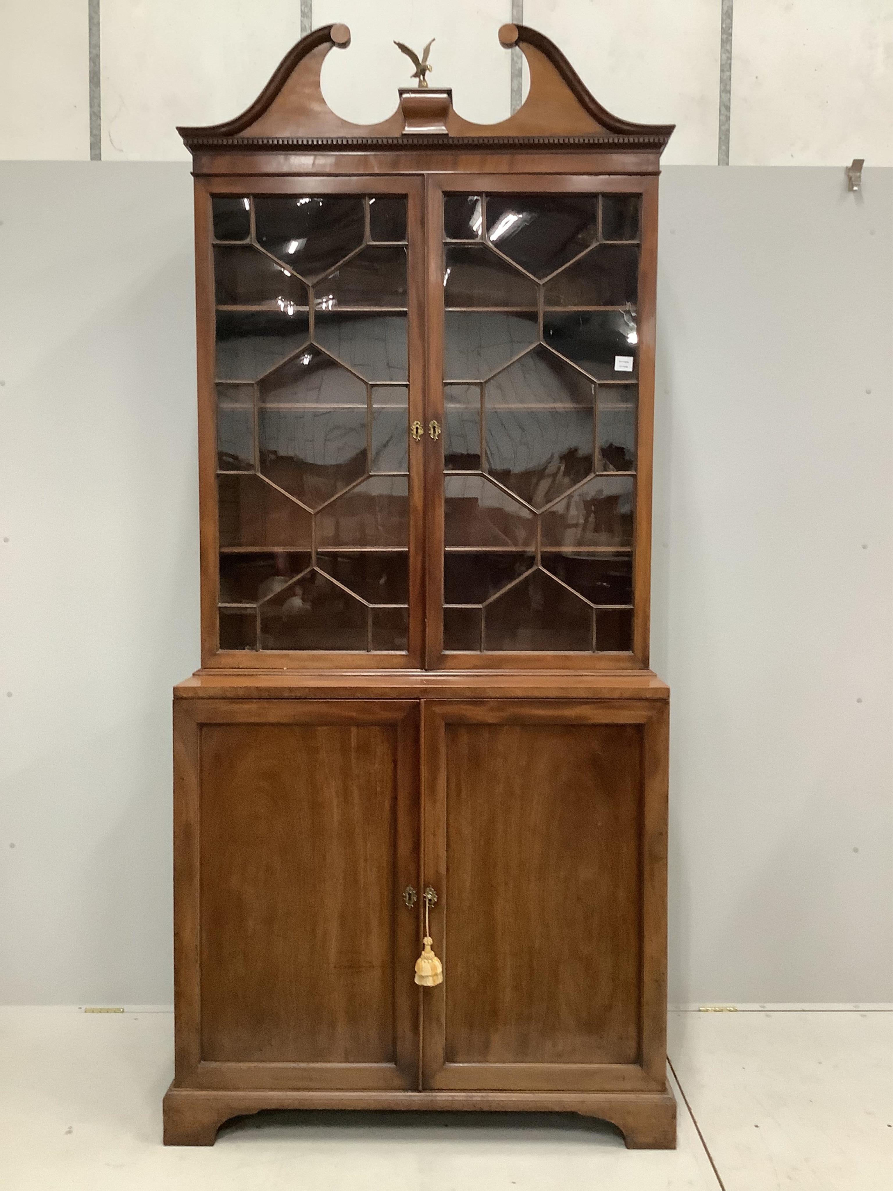 A George III mahogany bookcase cupboard, width 110cm, depth 56cm, height 248cm. Condition - fair